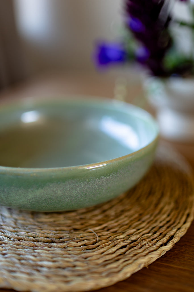  Rustic handmade ceramic pasta bowl in moss green glaze, perfect for serving pasta or salads.