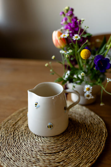 Handmade ceramic jug with 3D bee detail in cream glaze, perfect for milk or flowers.