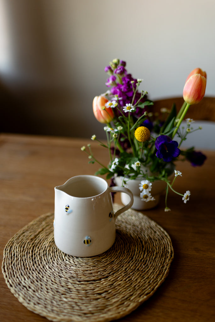 Handmade ceramic jug with 3D bee detail in cream glaze, perfect for milk or flowers.