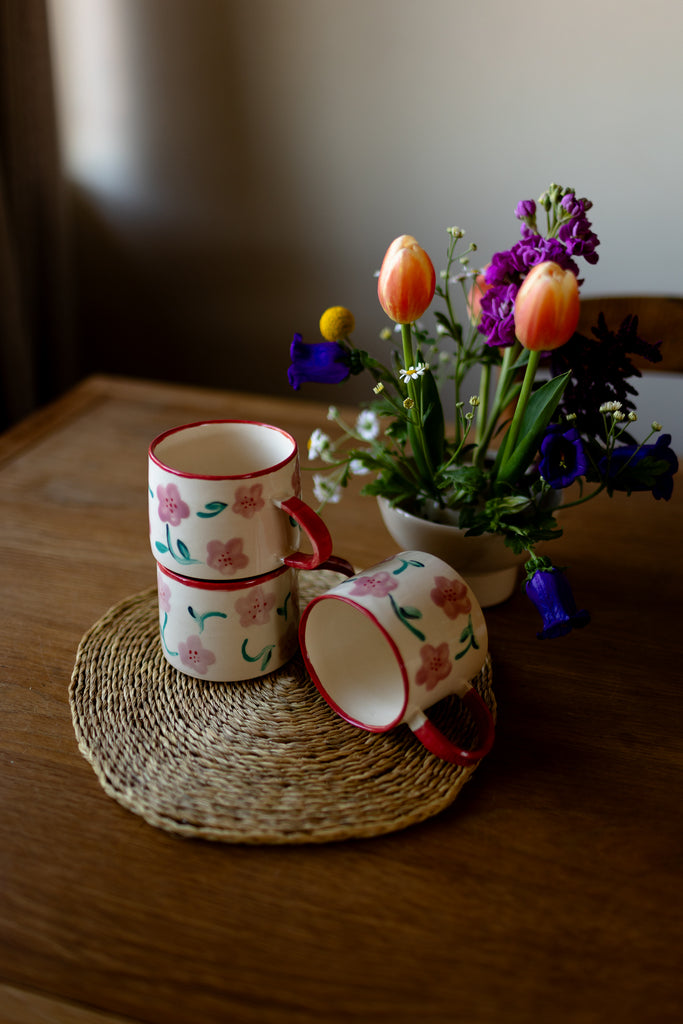Hand-painted ceramic mug with pink and red blossom design, 10x9cm, for coffee or tea.