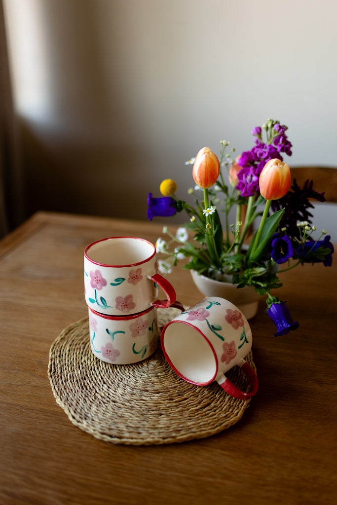 Hand-painted ceramic mug with pink and red blossom design, 10x9cm, for coffee or tea.