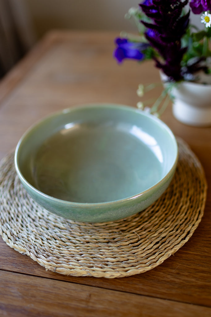  Rustic handmade ceramic pasta bowl in moss green glaze, perfect for serving pasta or salads.