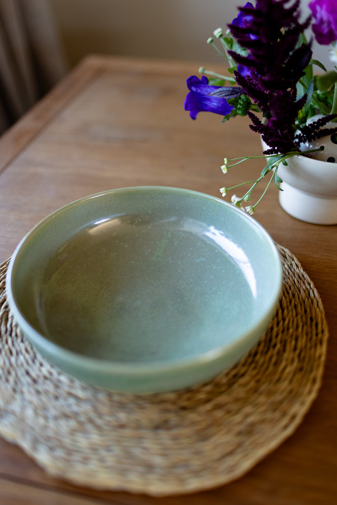  Rustic handmade ceramic pasta bowl in moss green glaze, perfect for serving pasta or salads.