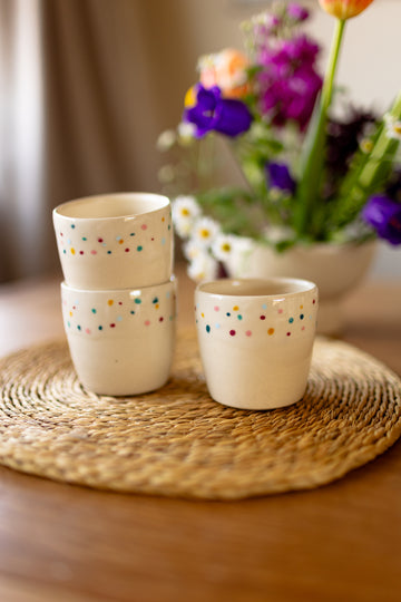 Small speckled ceramic espresso mugs in a creamy glaze, handmade stoneware.