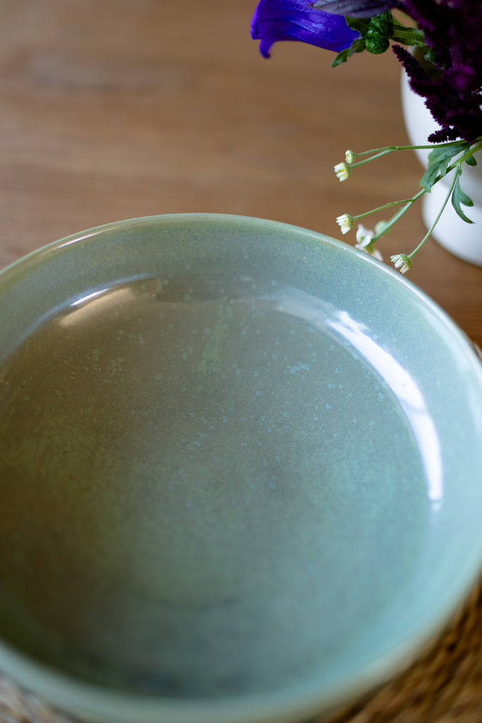  Rustic handmade ceramic pasta bowl in moss green glaze, perfect for serving pasta or salads.